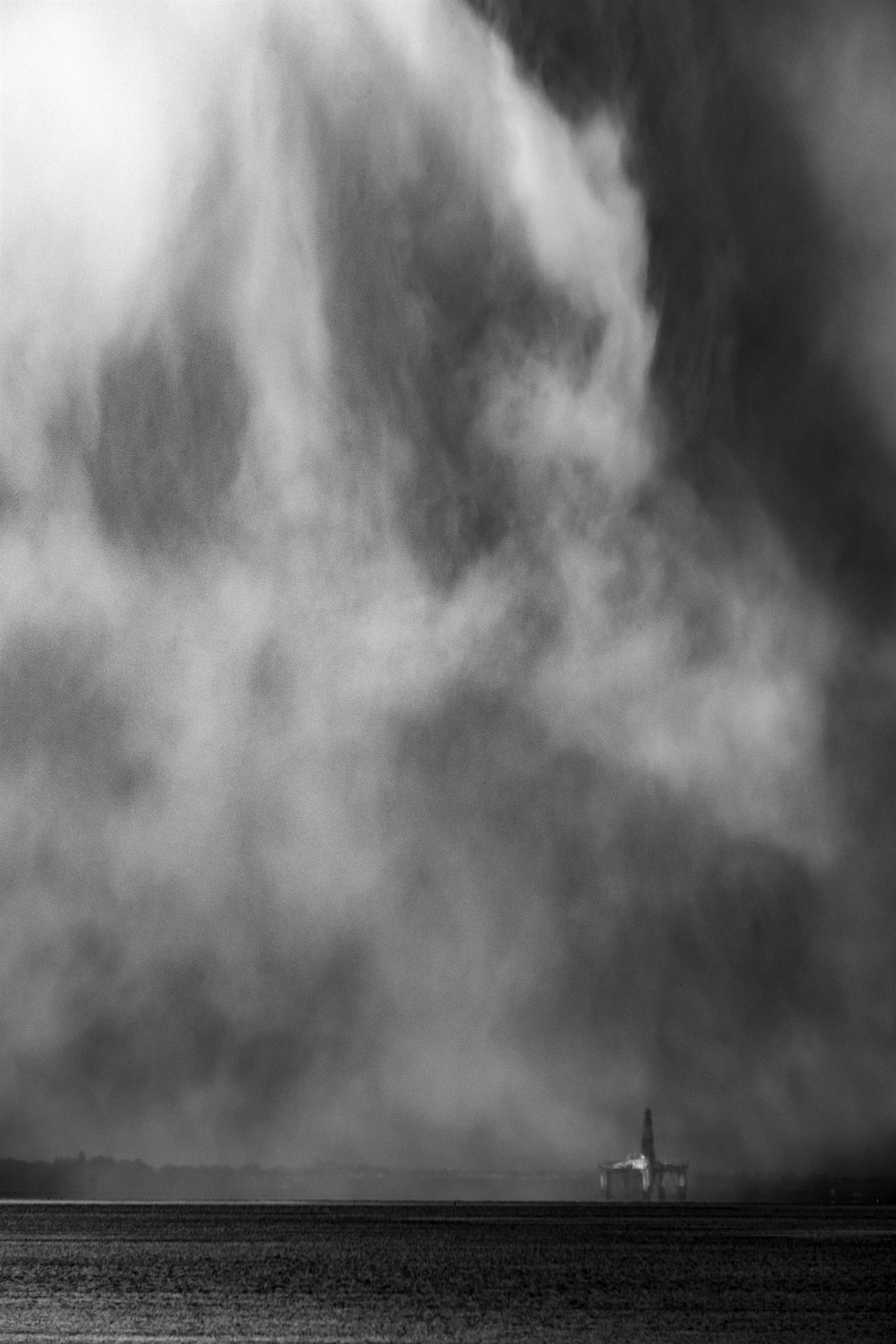 A shower falling from dark cloud over the sea