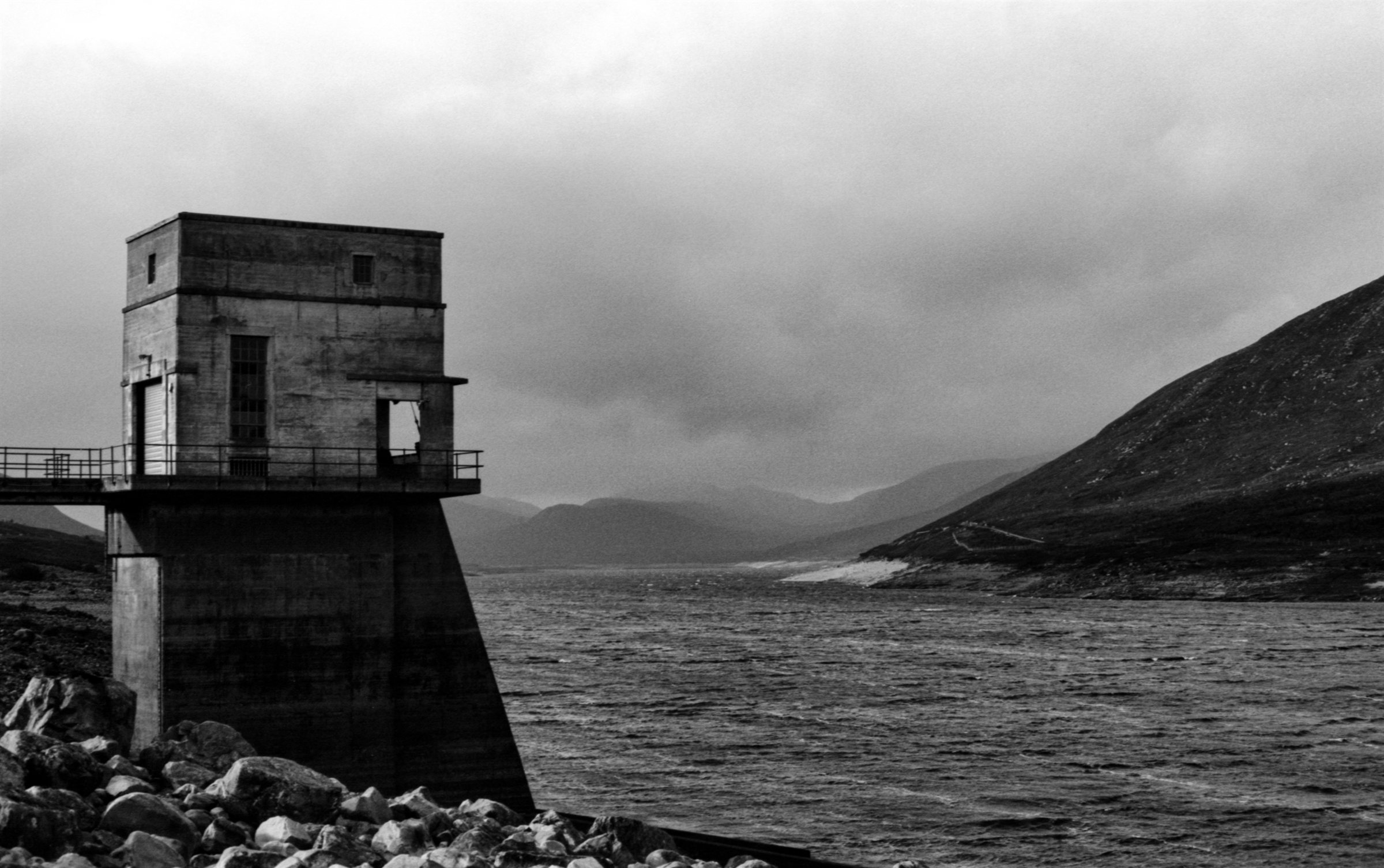 A dam tower above a windswept loch