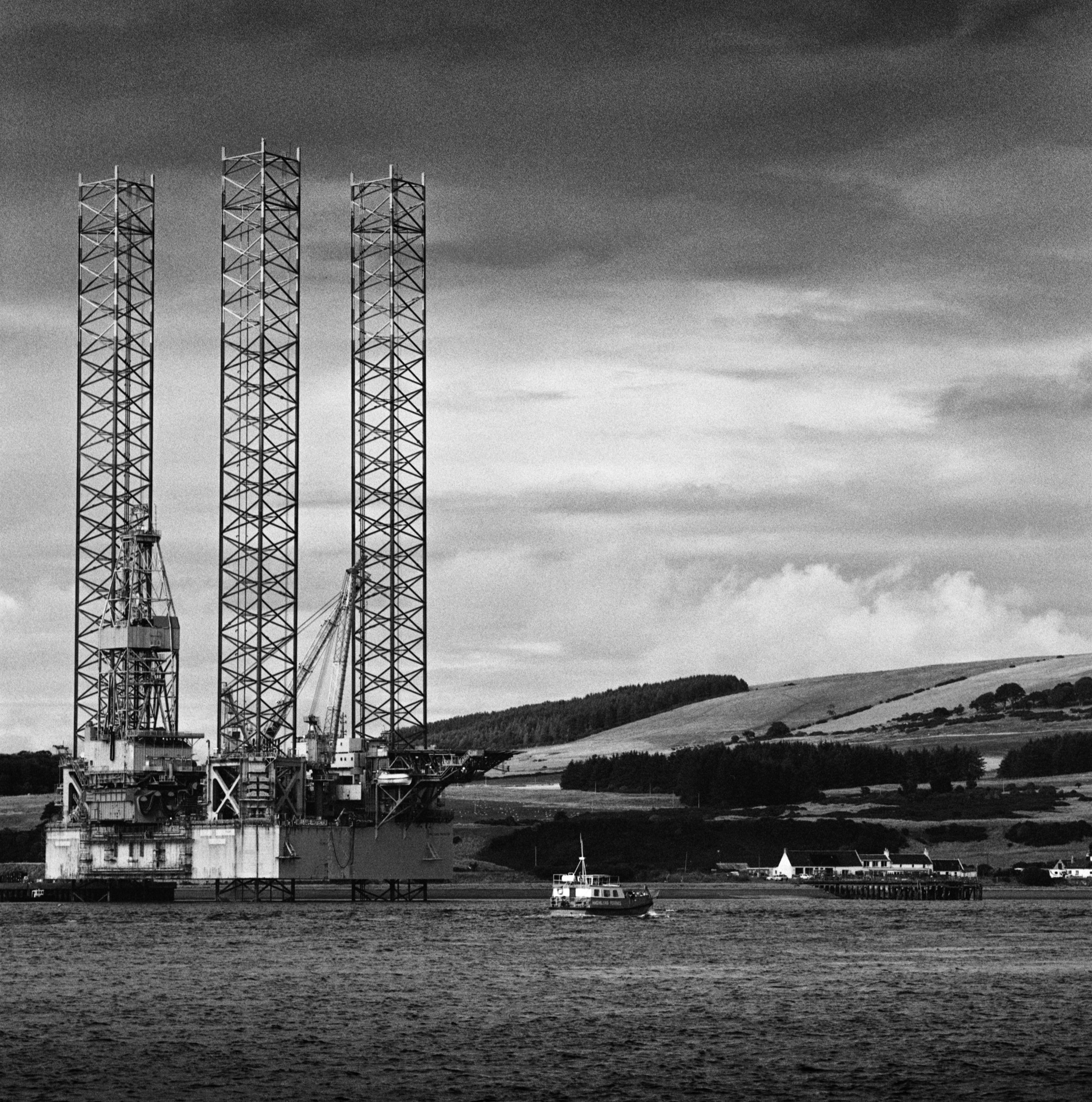 The three legs of a jack-up rig above the firth, a ferry crossing beneath