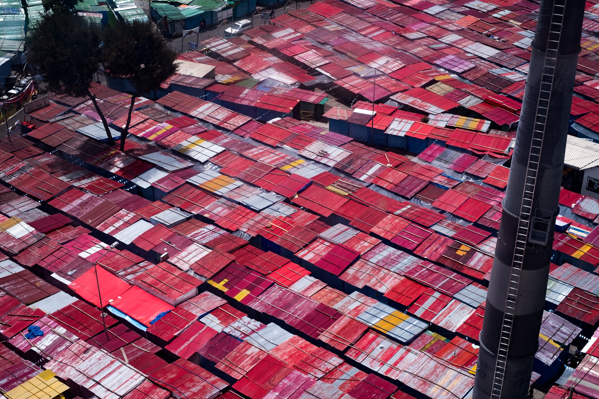 Red market roofs packed together, seen from above