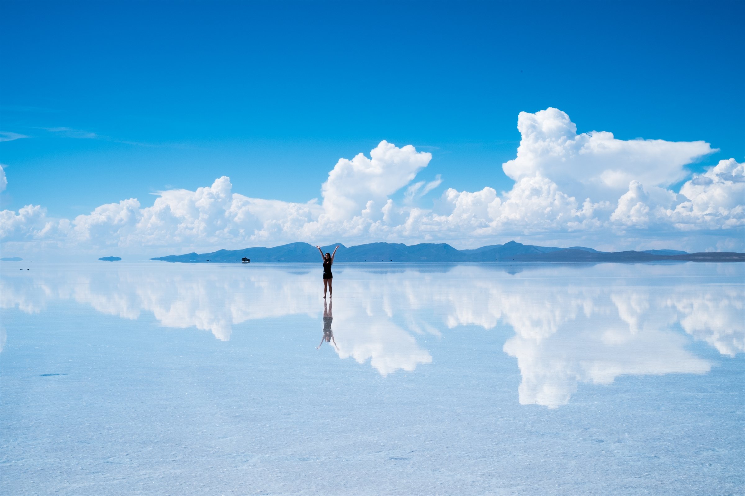 A lone figure on the mirror of the salt flats