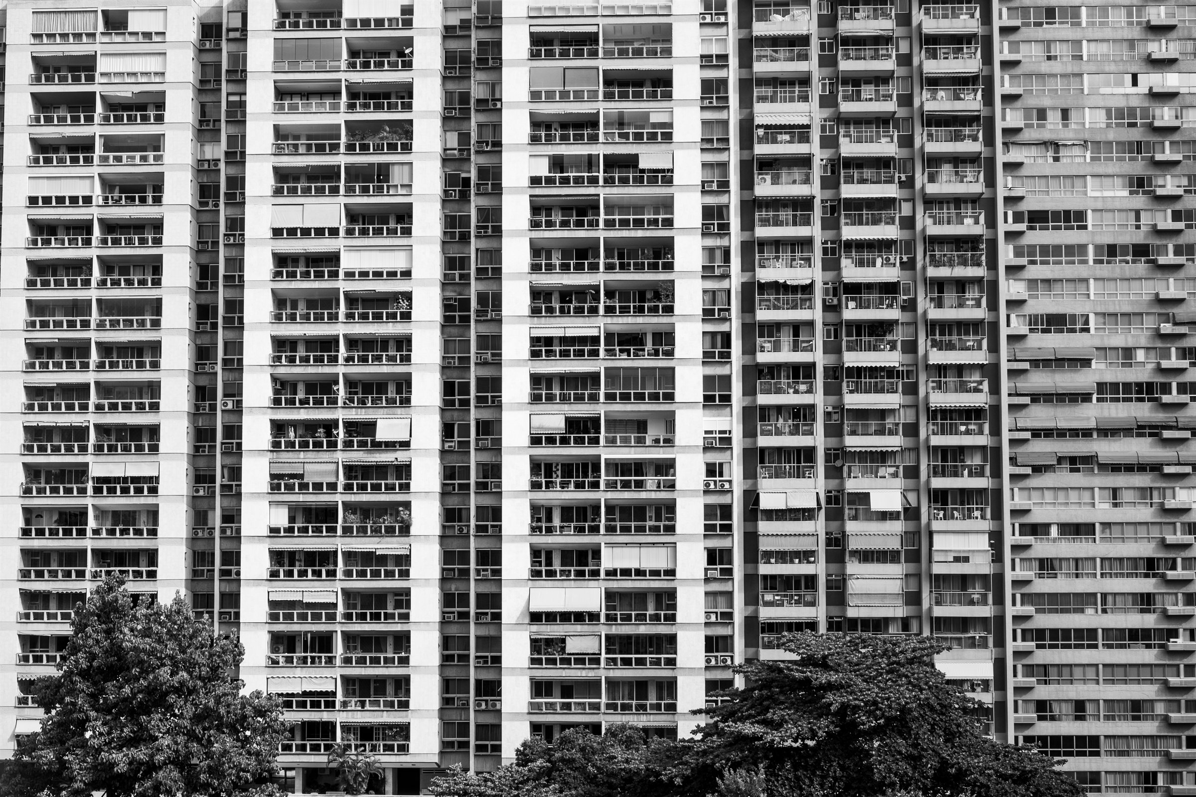 A tall tower block with rows of balconies