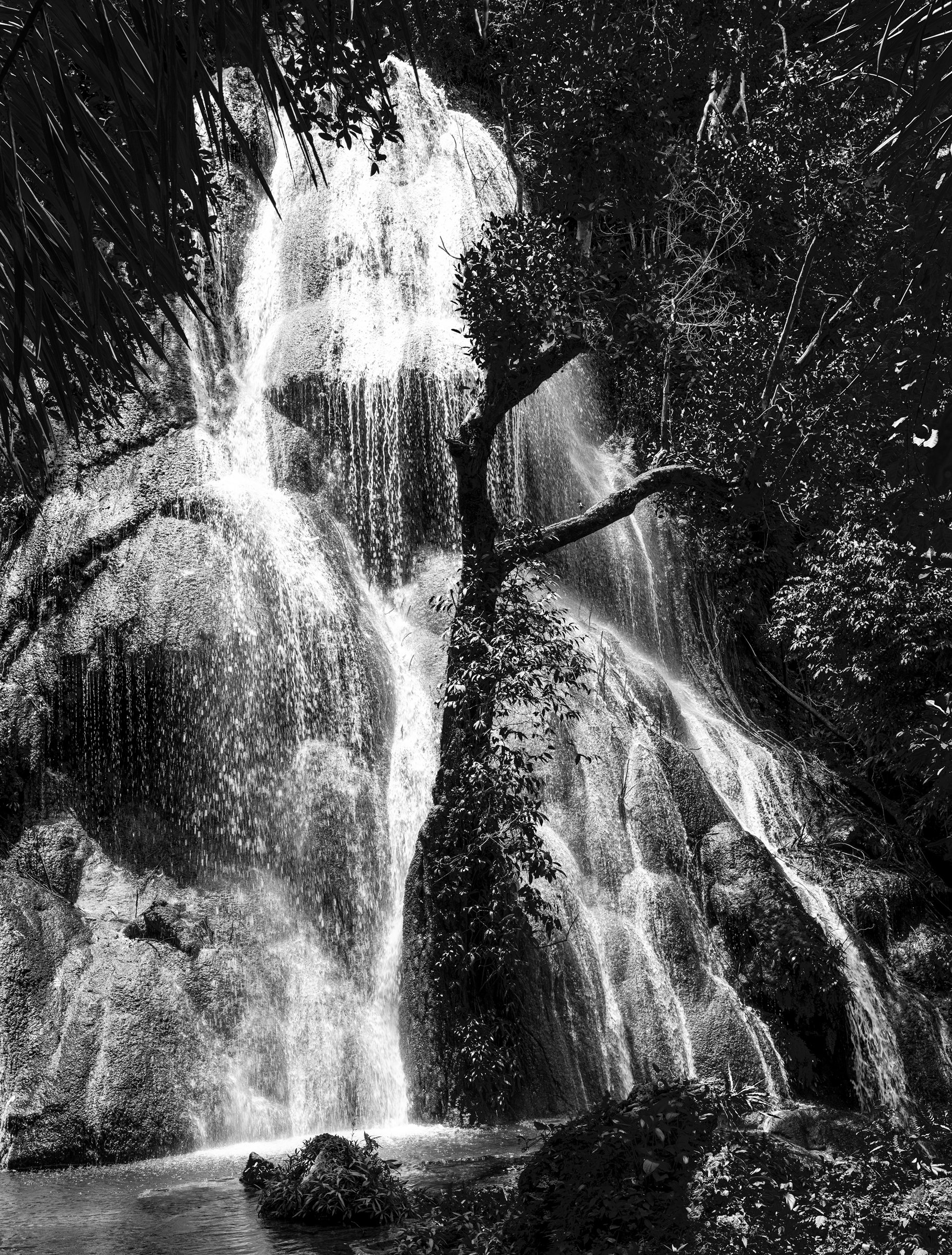 A tall waterfall pouring down a rock face
