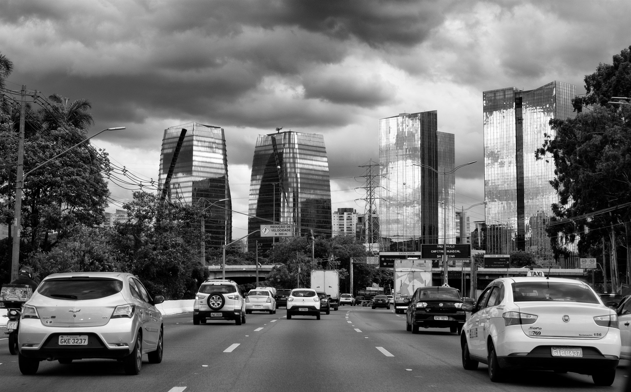 Traffic on a wide avenue between towers