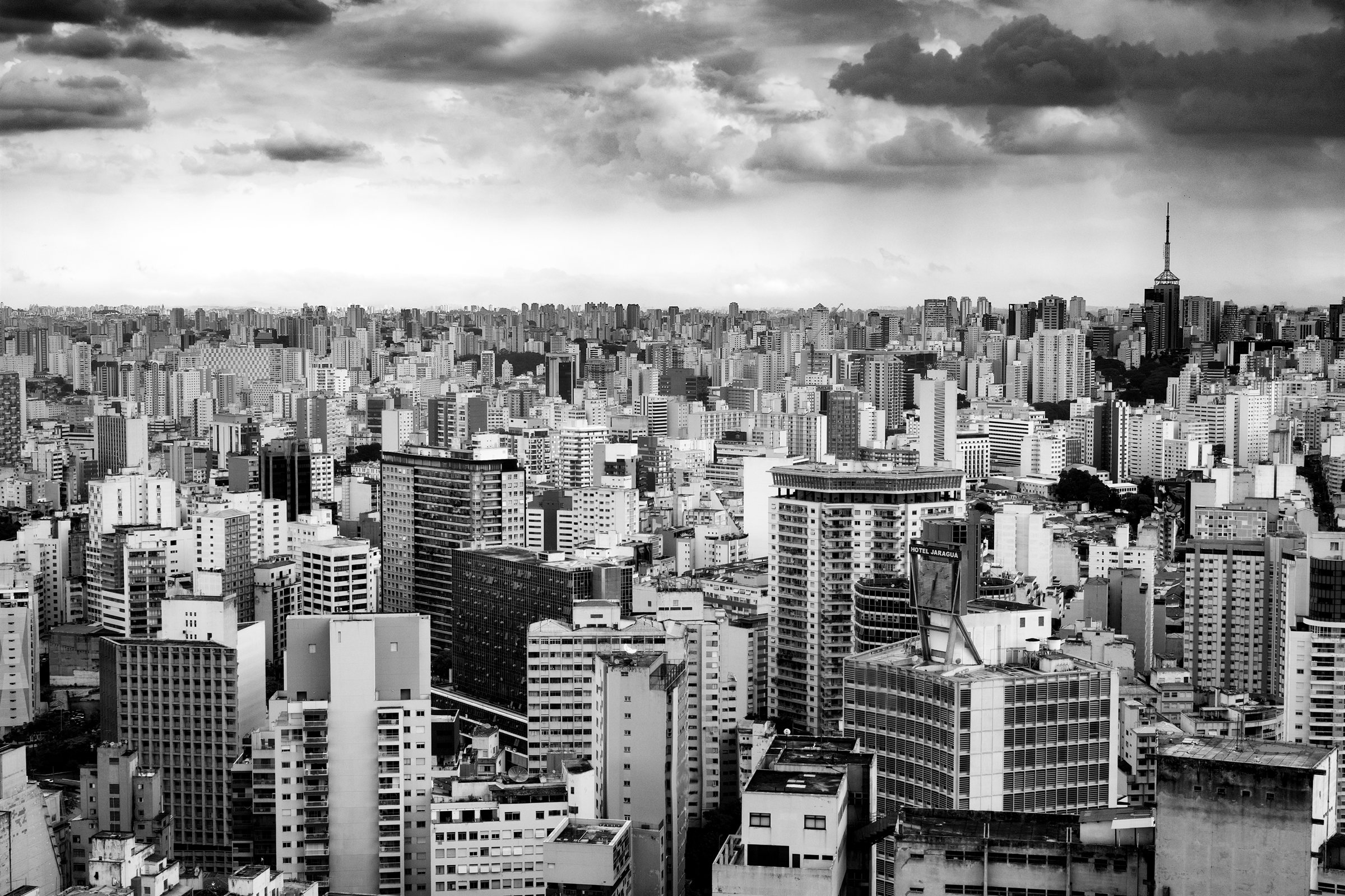 Crowded high-rise blocks under a stormy sky
