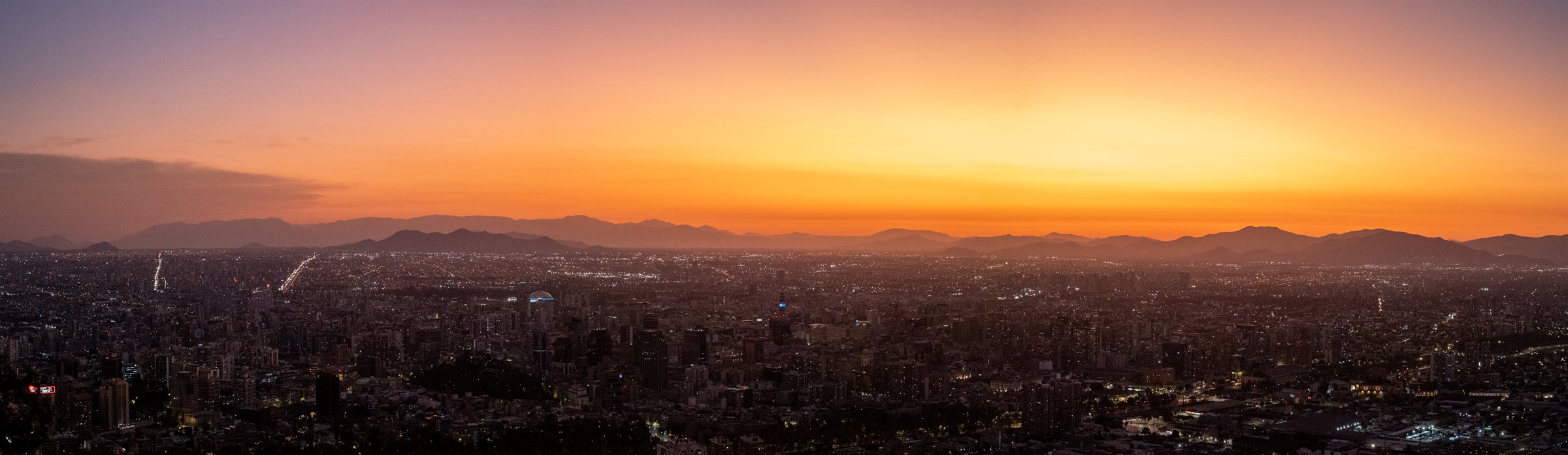 Santiago spread below an orange sunset sky