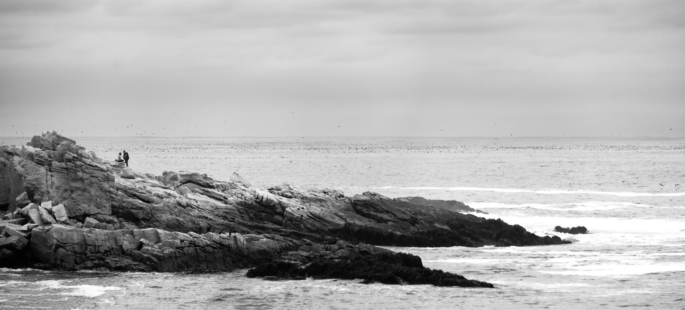 Rocks running out into a calm sea