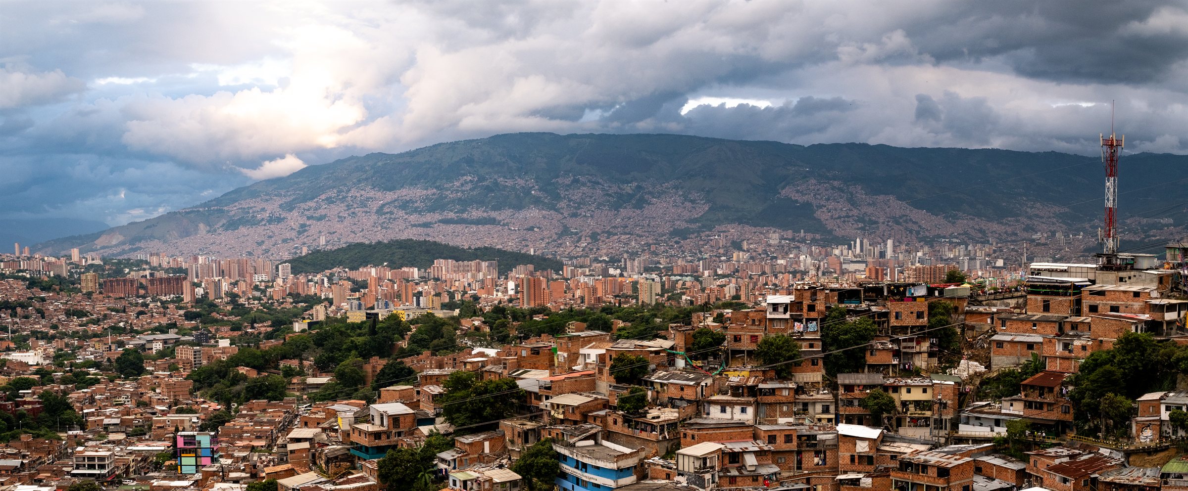 Medellín filling its valley beneath mountains and cloud